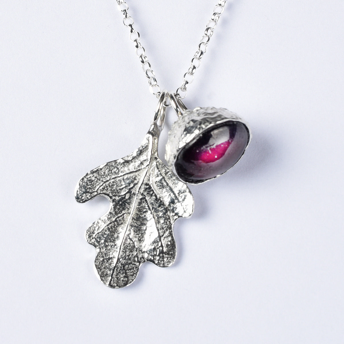 garnet acorn and oak leaf necklace on a white background