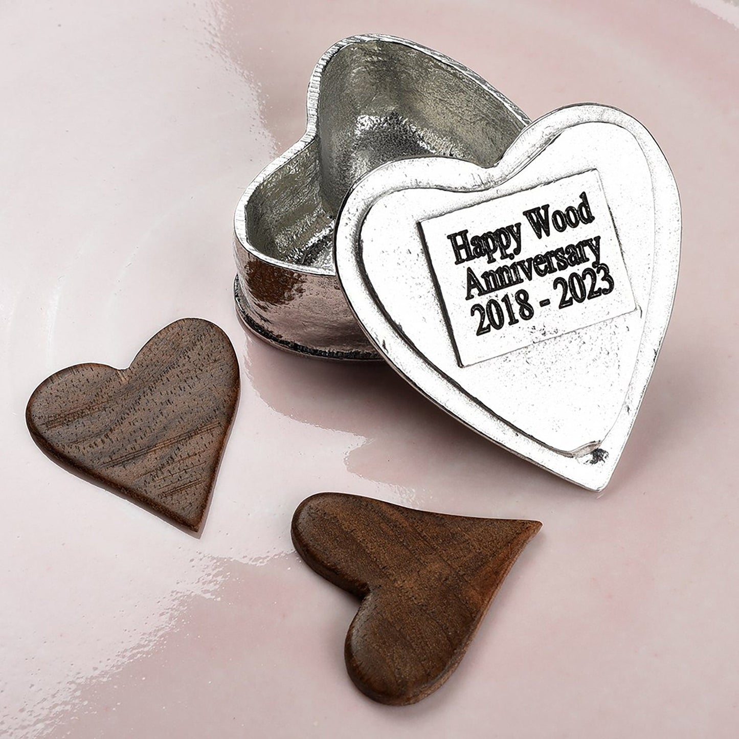 A personalised heart shaped pewter keepsake box with a garnet stone in the middle. The underside of the lid can be engraved with your personalised message. A perfect 10th (Tin) ten year wedding anniversary gift (Our pewter is 95% tin). 