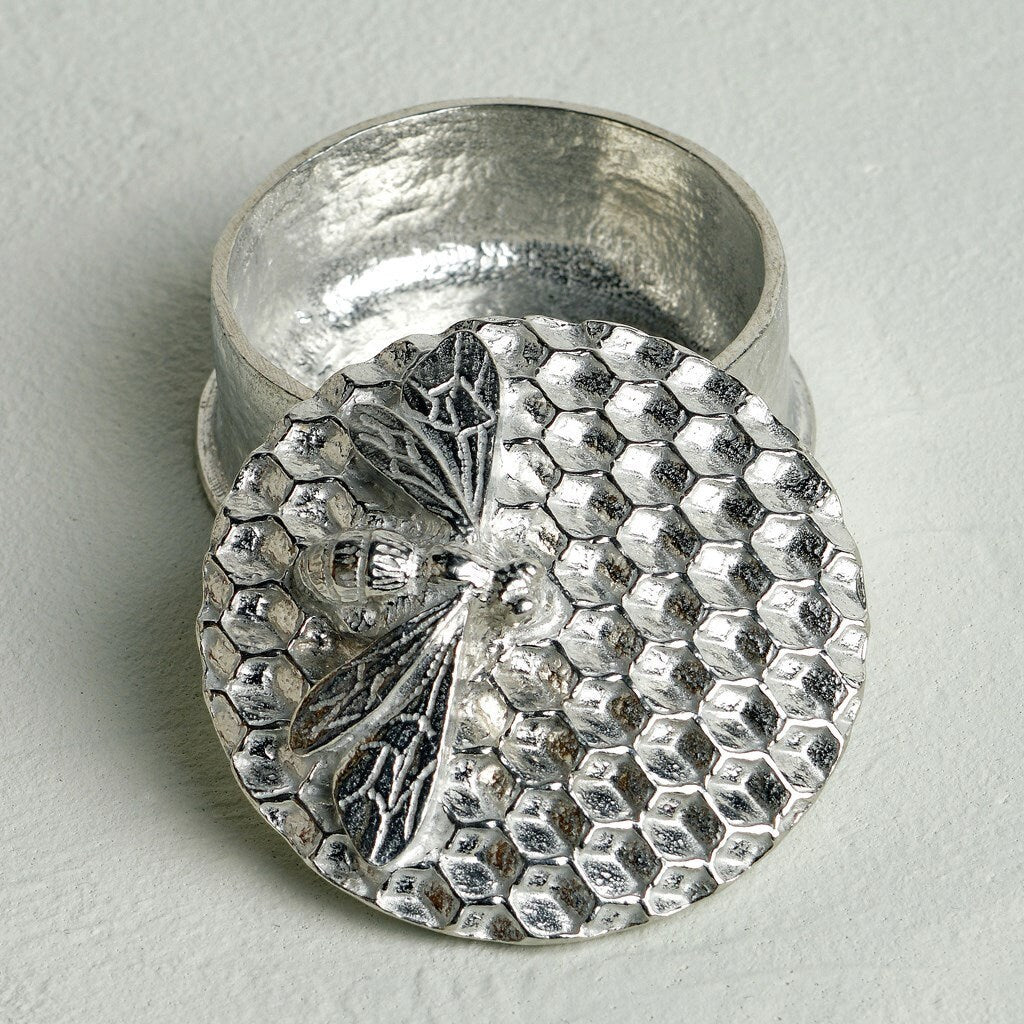 A little pewter trinket box has a honey bee resting on a bed of honeycomb on the lid. Great gifts for bee lovers, beekeepers and conservationists alike. Bee gifts, made in Britain.