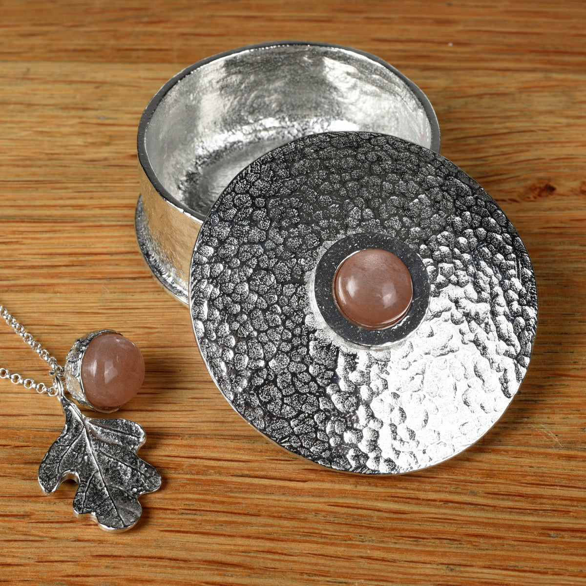 Moonstone personalised, engraved birthstone box with Moonstone acorn oak leaf necklace on a wooden surface. June birthstone gifts
