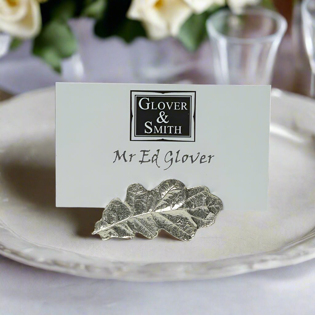 A striking & beautifully detailed pewter oak leaf place card holder. Ideal for place settings at a wedding. The oak leaf symbolises: strength, stability, hospitality, honour, eternity & liberty. Great little gift for nature lovers.