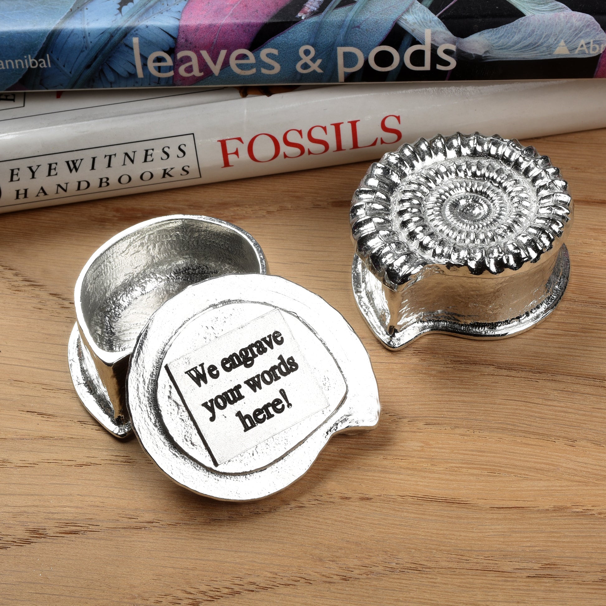 Ammonite pewter trinket box, we can engrave the inside of the lid with your message. A small fossil shaped keepsake box in the shape of an ammonite fossil. We used a real ammonite found in Dorset to capture the true texture and feel of a real fossil. Geology gifts made in Britain.