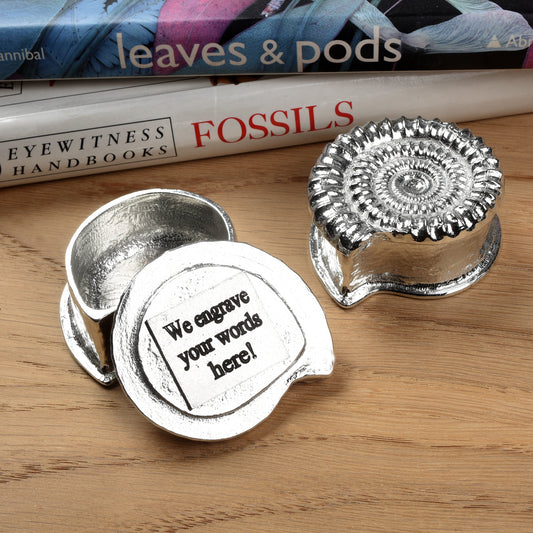 Ammonite pewter trinket box, we can engrave the inside of the lid with your message. A small fossil shaped keepsake box in the shape of an ammonite fossil. We used a real ammonite found in Dorset to capture the true texture and feel of a real fossil. Geology gifts made in Britain.