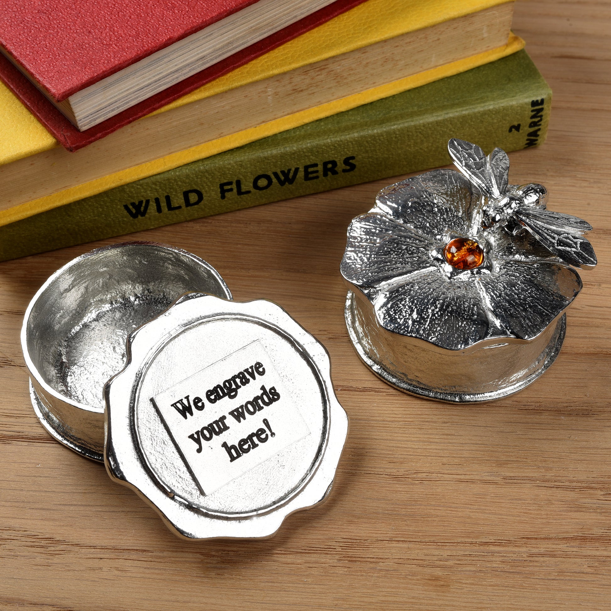 A forget me not flower pewter keepsake trinket box with an amber stone in the middle with a bee sculpture. Bee gifts, gifts for bee lovers. We engrave the underside of the lid with your message.