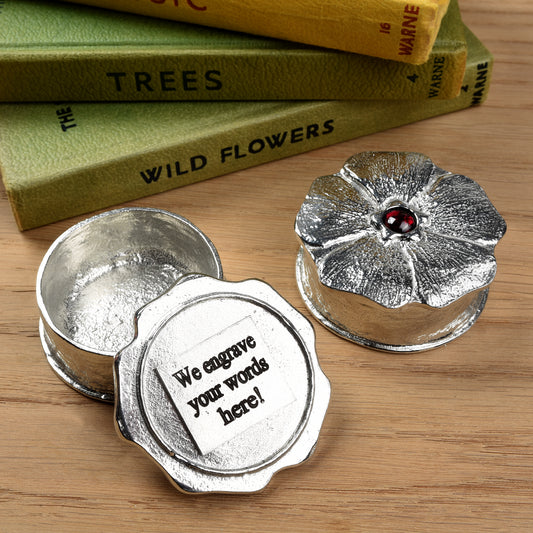 A forget me not flower pewter keepsake trinket box has a garnet stone in the middle. We engrave the underside of the lid with your message. A perfect 10th (Tin) ten year wedding anniversary gift (Our pewter is 95% tin). Great gifts for bridesmaids or a small wedding gift.