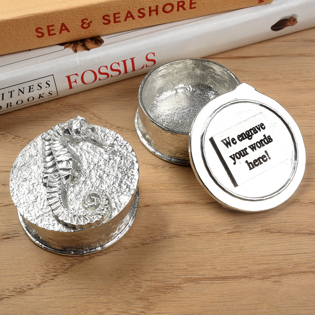 A round  pewter trinket box with a seahorse on the lid. We personalise it by engraving on the underside of the lid. Nautical gifts for lovers of the seaside and sea life. Seahorse gifts, gifts for seahorse lovers.