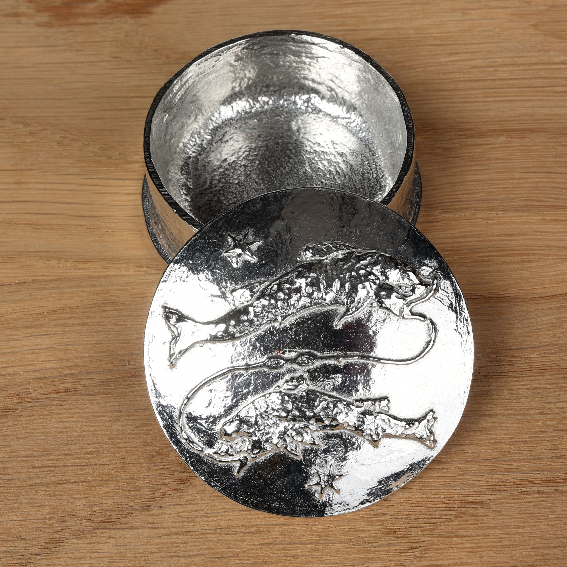 A beautifully detailed and textured Pisces zodiac sign guards precious treasure on this lovely personalised pewter trinket box. The underside of the lid can be engraved with your personalised message. Birthday gifts for Pisceans.