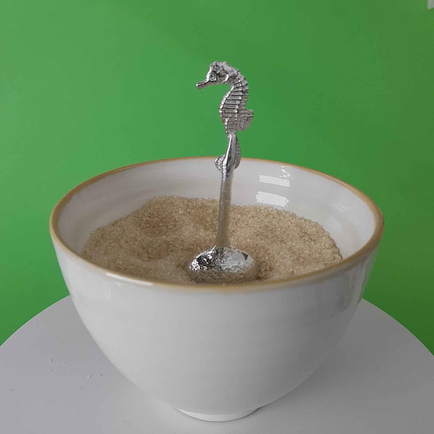 Video of a handmade pewter spoon with a seahorse on the handle. The spoon is in a revolving sugar bowl.