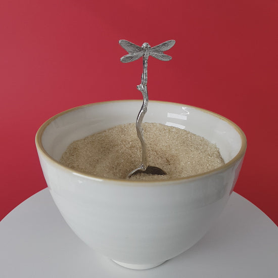 Video of a handmade pewter spoon with a dragonfly handle. The spoon is in a revolving sugar bowl.