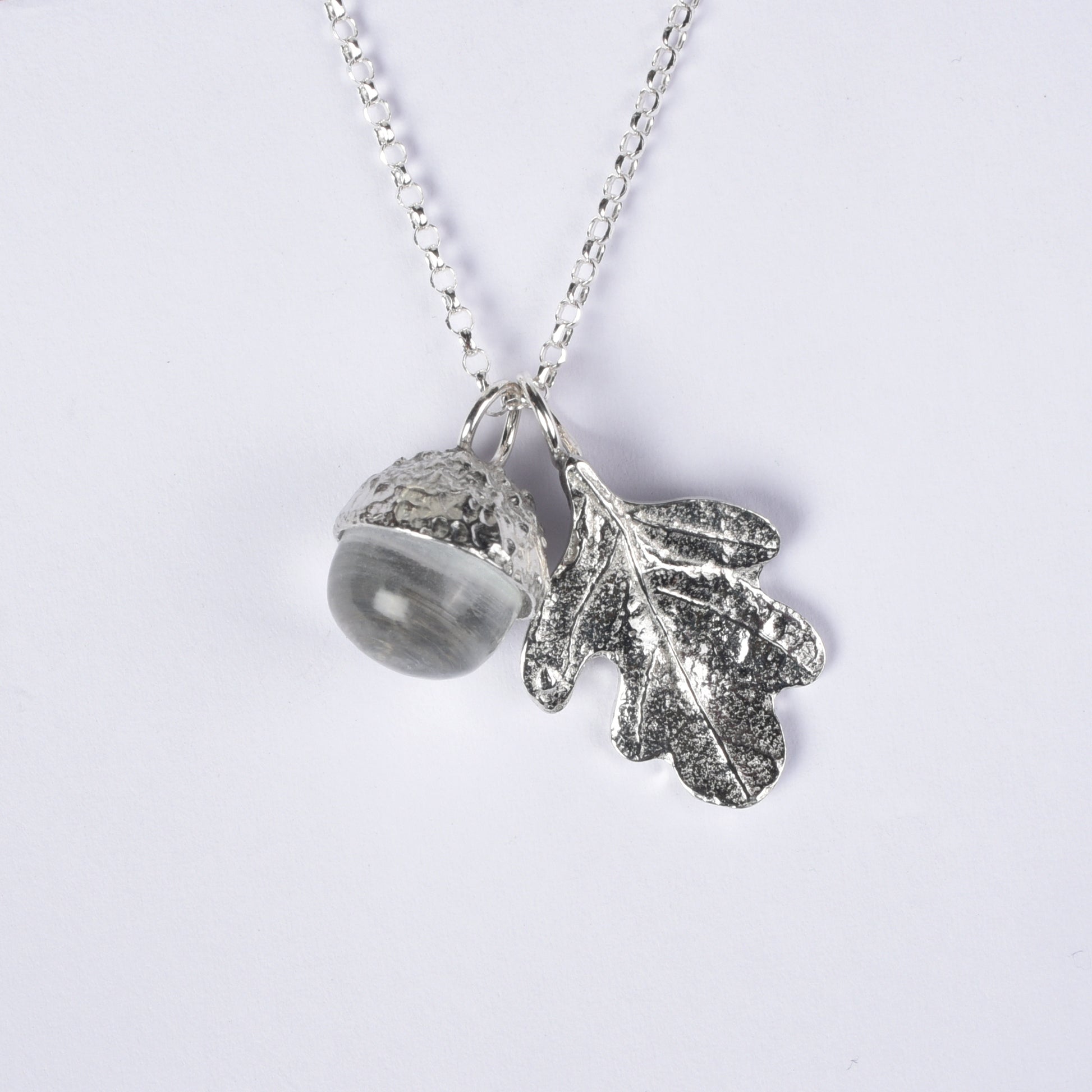 Pewter jewellery, an oak leaf necklace with an acorn cup with an rock crystal stone in it, April birthstone jewellery on a Sterling silver chain.