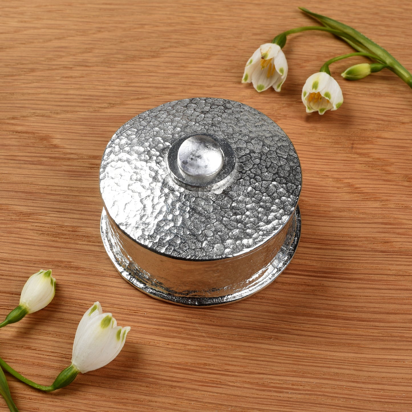 Rock Crystal Birthstone Box with white flowers on a wooden surface. April birthstone box gift. Pewter gifts handmade in the UK.
