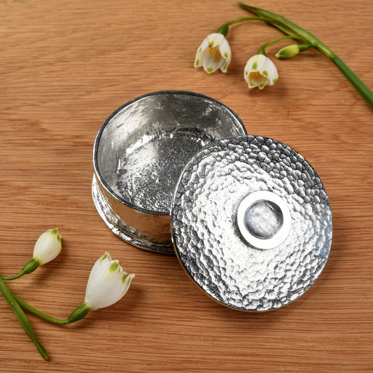 Rock Crystal Birthstone Box with white flowers on a wooden surface. April birthstone box gift. Pewter gifts handmade in the UK.