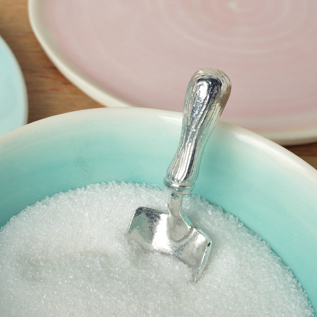 A small spoon pewter sugar spoon in the shape of a garden trowel . Unusual, useful and tactile gifts for gardeners and garden lovers handmade in the UK useful countryside gifts