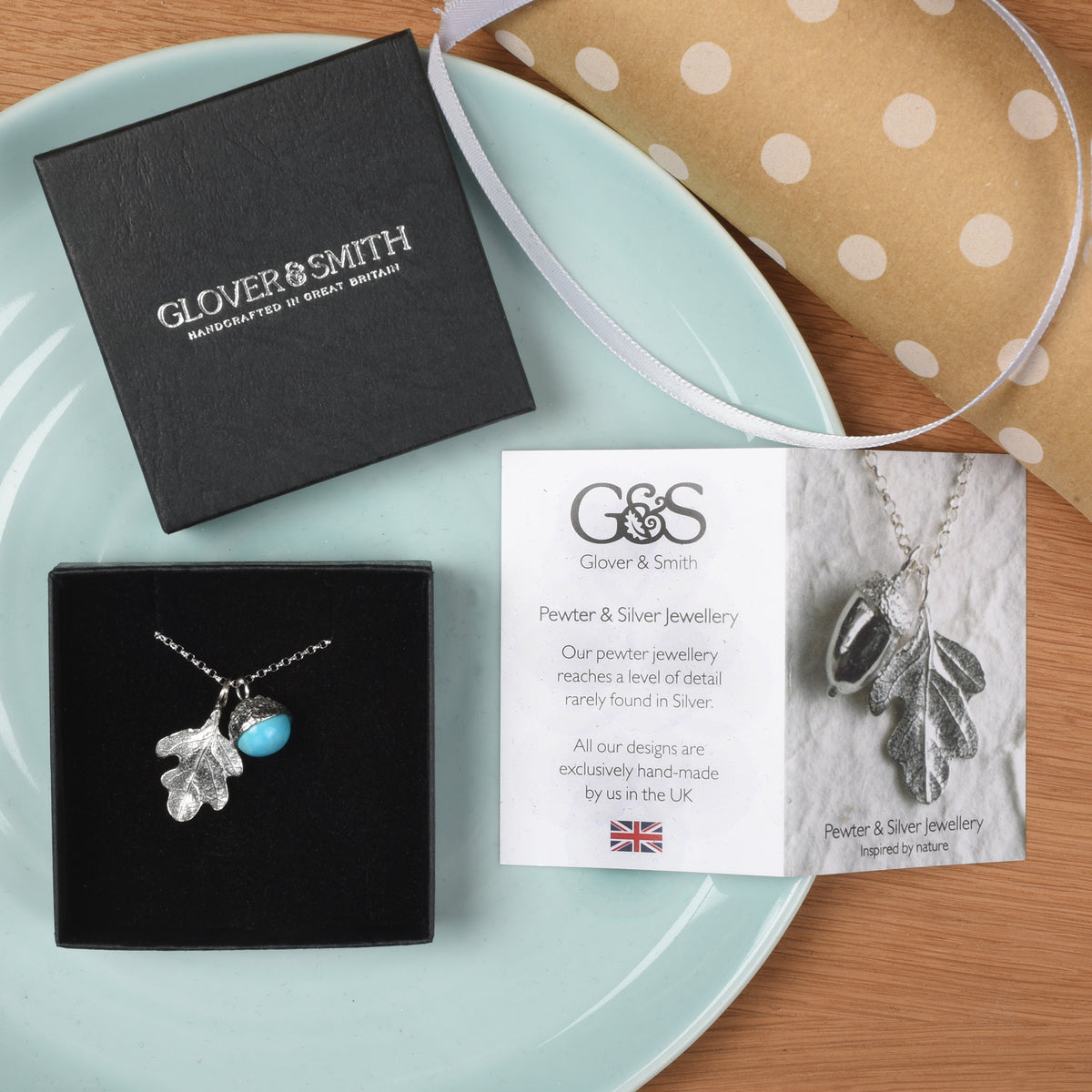A  turquoise acorn and oak leaf pewter necklace. December birthstone gifts shown with its gift packaging