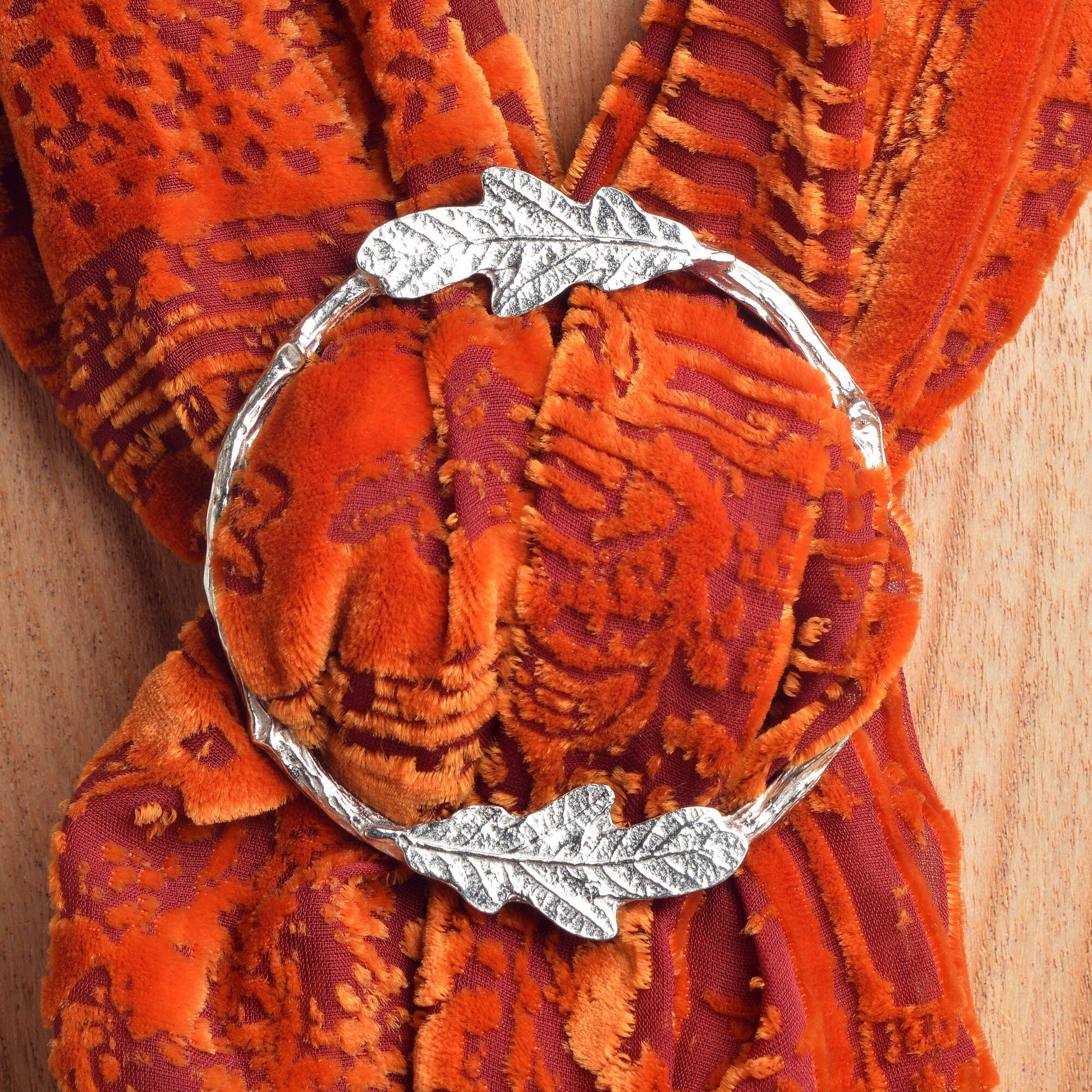 Oak leaf scarf ring. Two detailed oak leaves rest on a twig textured ring on this decorative pewter ring for scarves. It will fit most large velvet, silk, cotton or wool scarves. Oak leaf gifts, gifts for nature lovers.