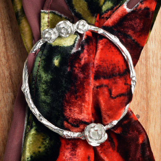 Rose scarf ring. A cluster of roses rest on a twig textured ring on this decorative pewter ring for scarves. It will fit most large velvet, silk, cotton or wool scarves. Gifts for gardeners, gifts for nature lovers, rose gifts.