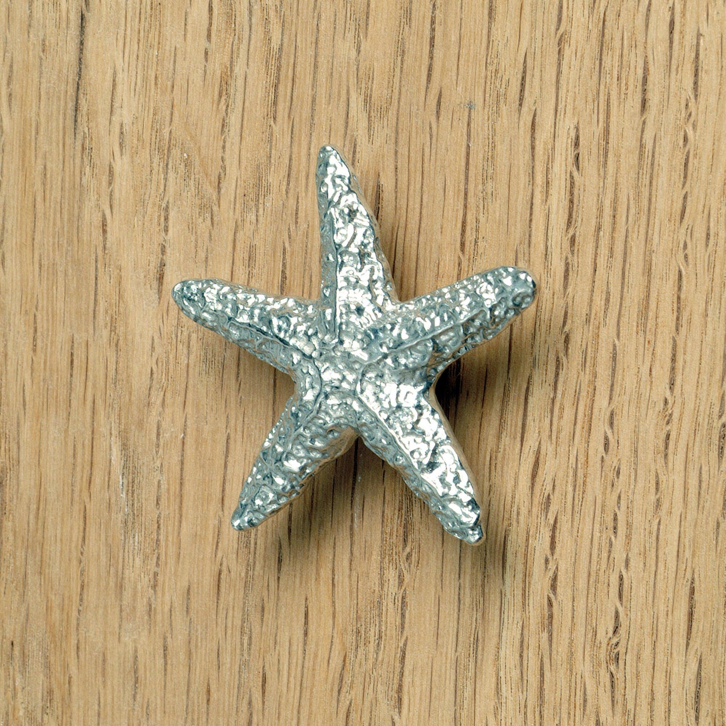 A solid pewter cabinet handle, cupboard knob, furniture handle or drawer pull in the shape of a detailed starfish. Organic, unusual handles UK handmade with finesse