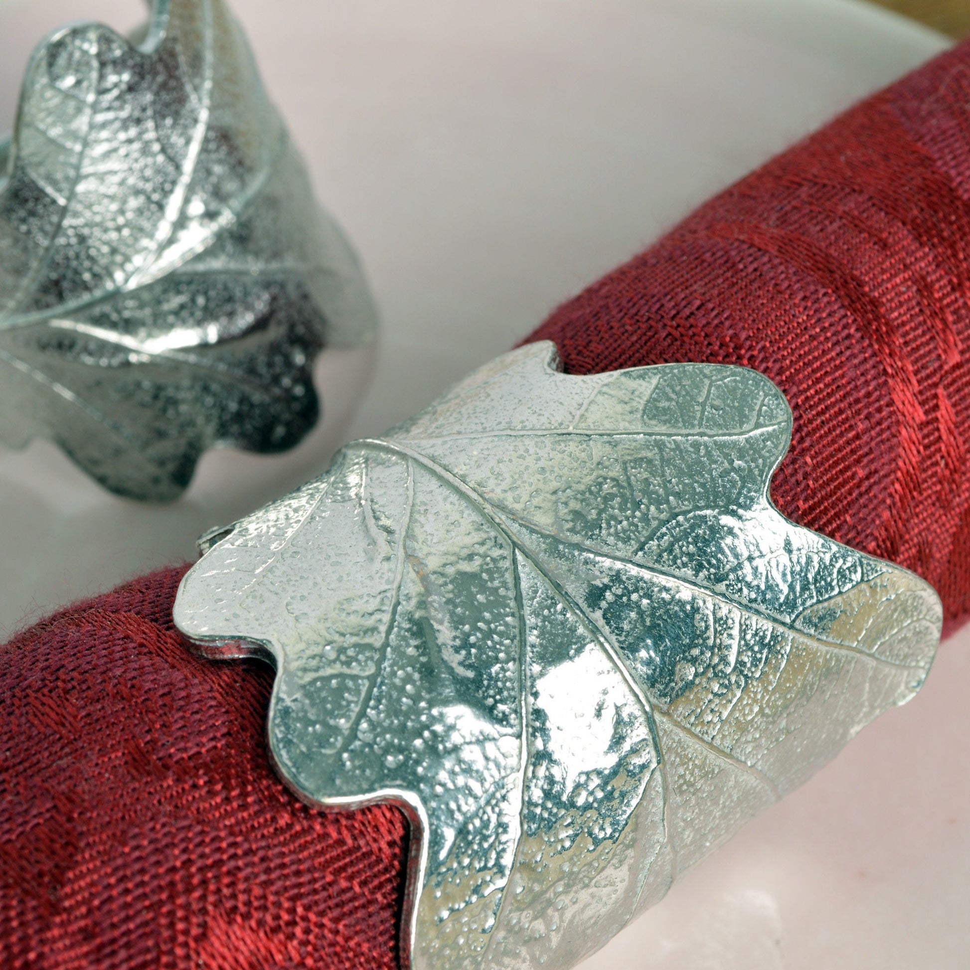 Oak leaf & acorn napkin rings pair. Detailed cast oak leaves with acorns curled into a practical & useful pair of serviette rings. Small wedding gifts, gifts for nature lovers. Pewter tableware gifts for couples. Housewarming or wedding gifts UK made