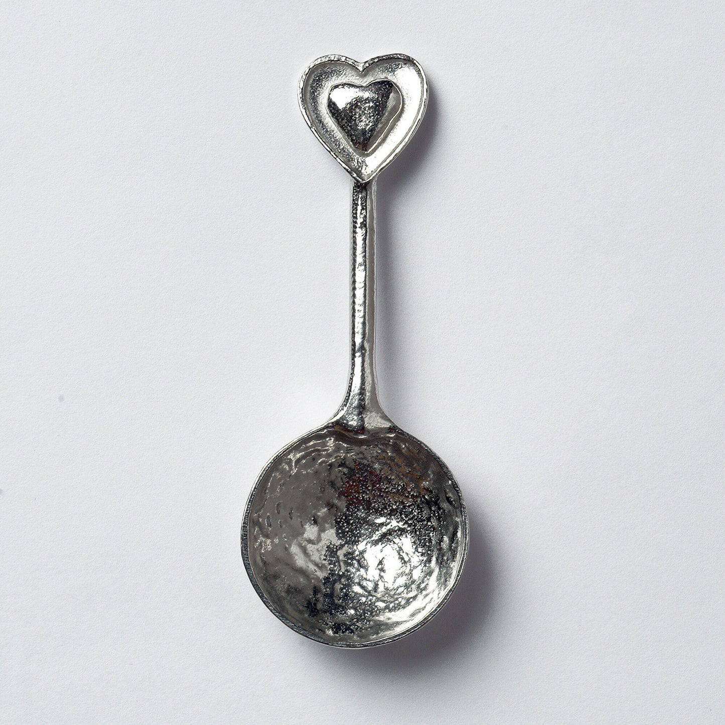 A small spoon pewter sugar spoon  with 2 love hearts on the end. Our love spoon makes an ideal little love token or 10th tin wedding anniversary gift or small wedding gift.