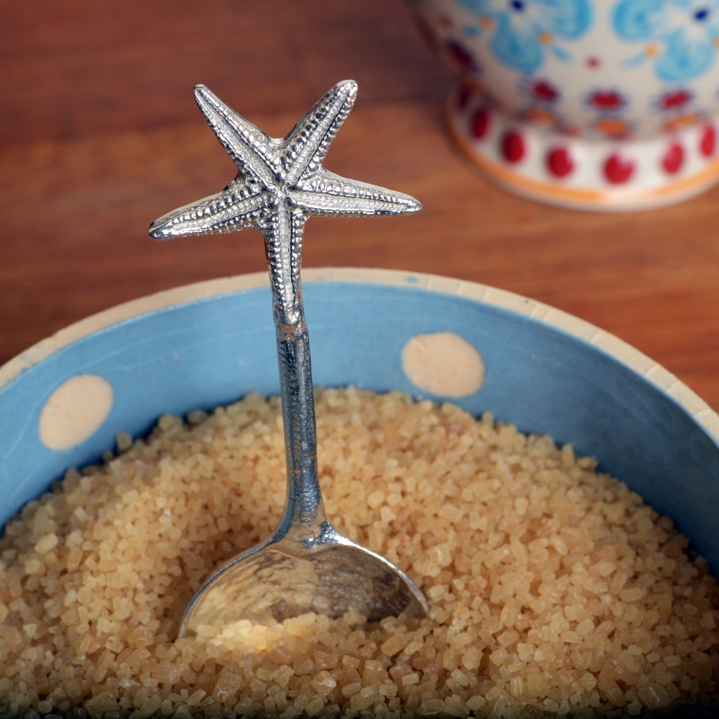 A small spoon pewter sugar spoon. A round bowled spoon on a straight handle leads to a perfectly sculpted starfish. Practical & useful nautical gifts for starfish lovers. UK handmade