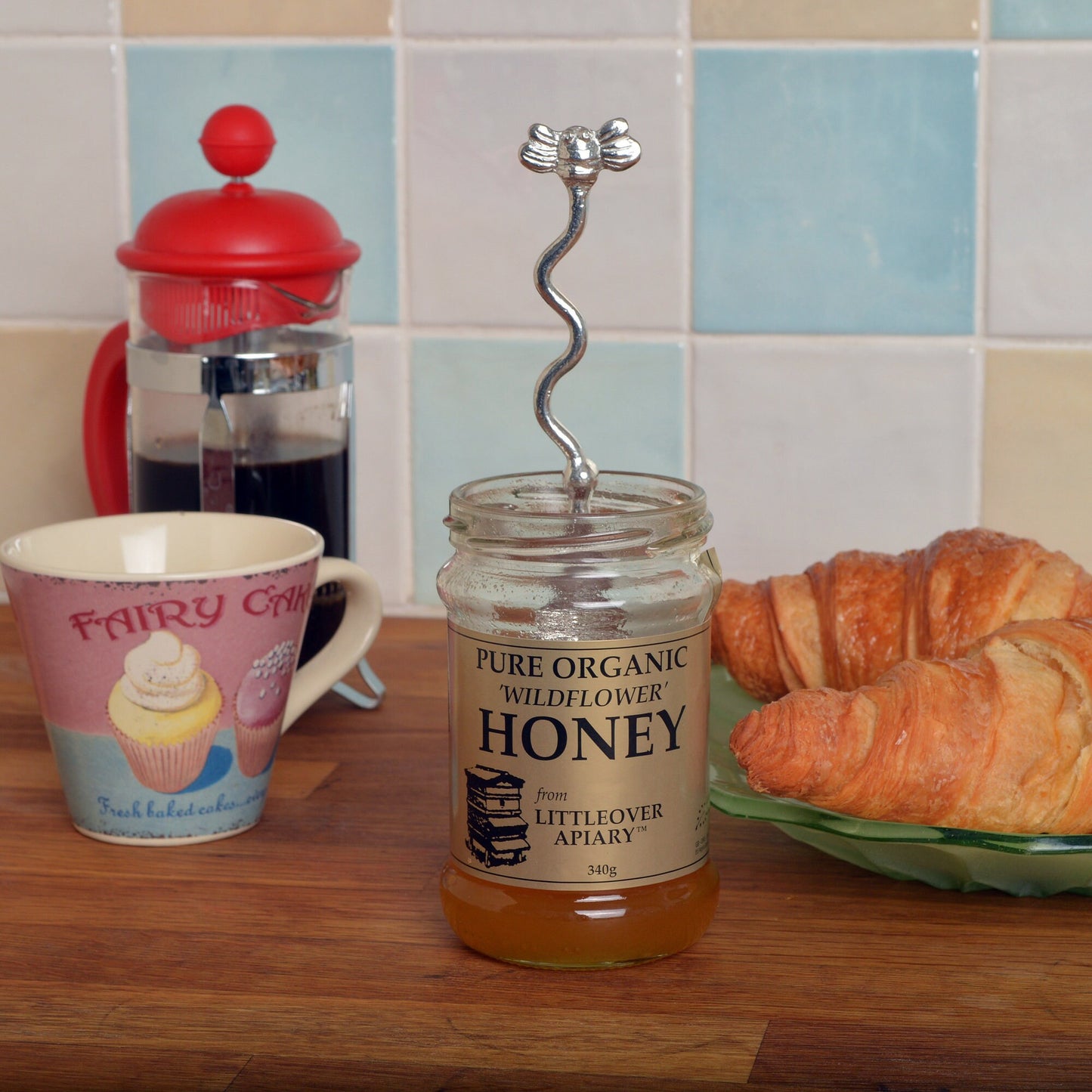 A long handled pewter honey spoon with a bee on the end and a hook to hang from any jar. Ideal gifts for bee Lovers and honey lovers. No more sticky fingers with our long handled spoons. UK made bee gifts. Ideal jam spoons or honey spoons.