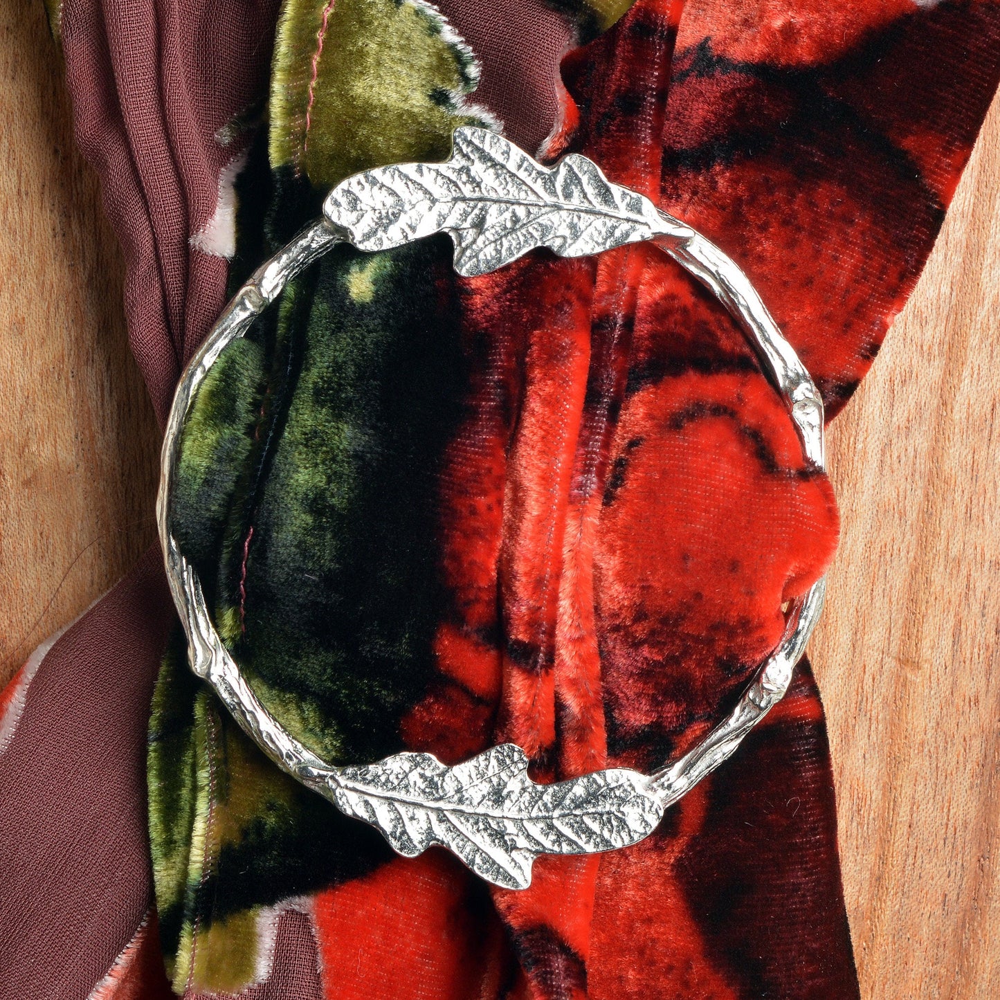 Oak leaf scarf ring. Two detailed oak leaves rest on a twig textured ring on this decorative pewter ring for scarves. It will fit most large velvet, silk, cotton or wool scarves. Oak leaf gifts, gifts for nature lovers.