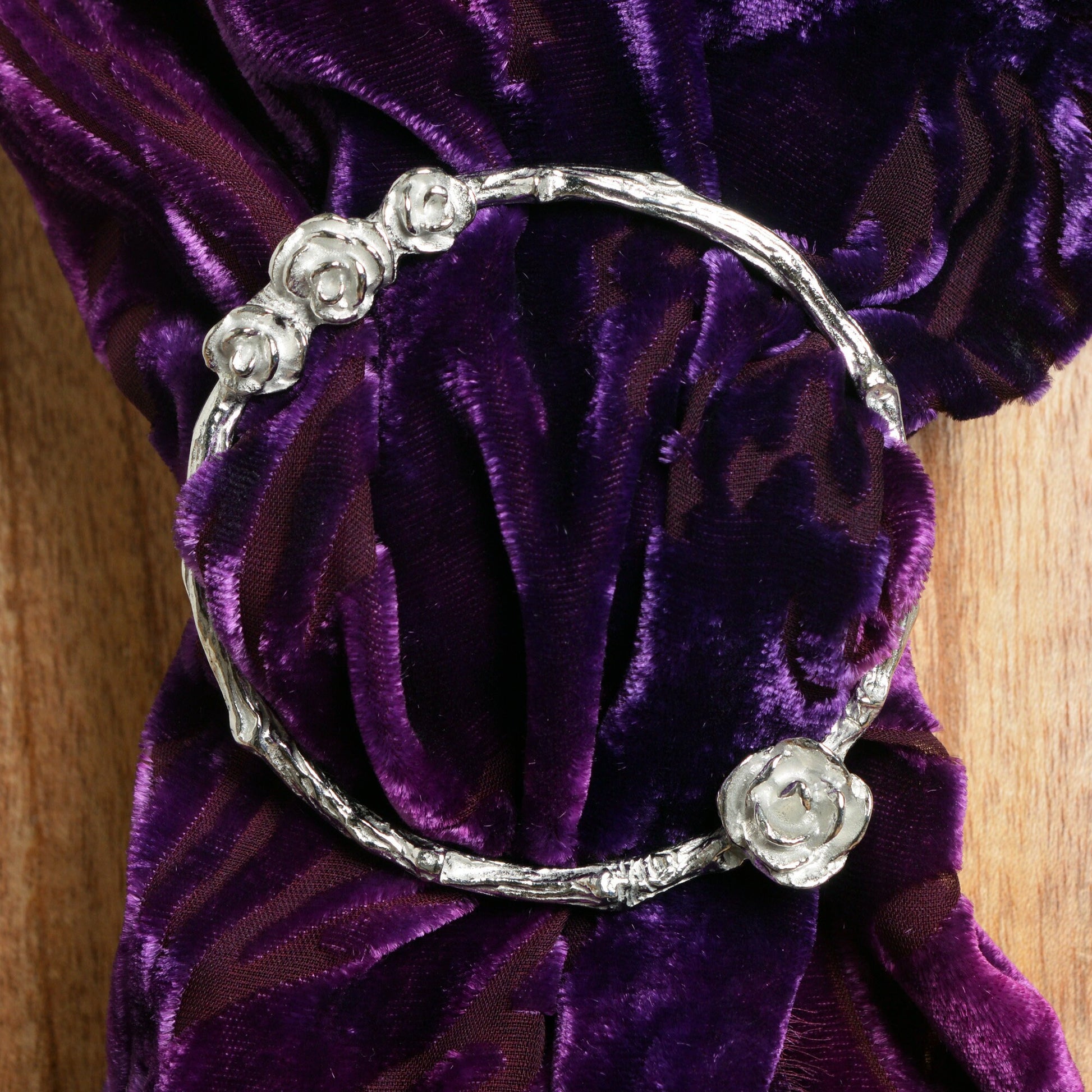 Rose scarf ring. A cluster of roses rest on a twig textured ring on this decorative pewter ring for scarves. It will fit most large velvet, silk, cotton or wool scarves. Gifts for gardeners, gifts for nature lovers, rose gifts.