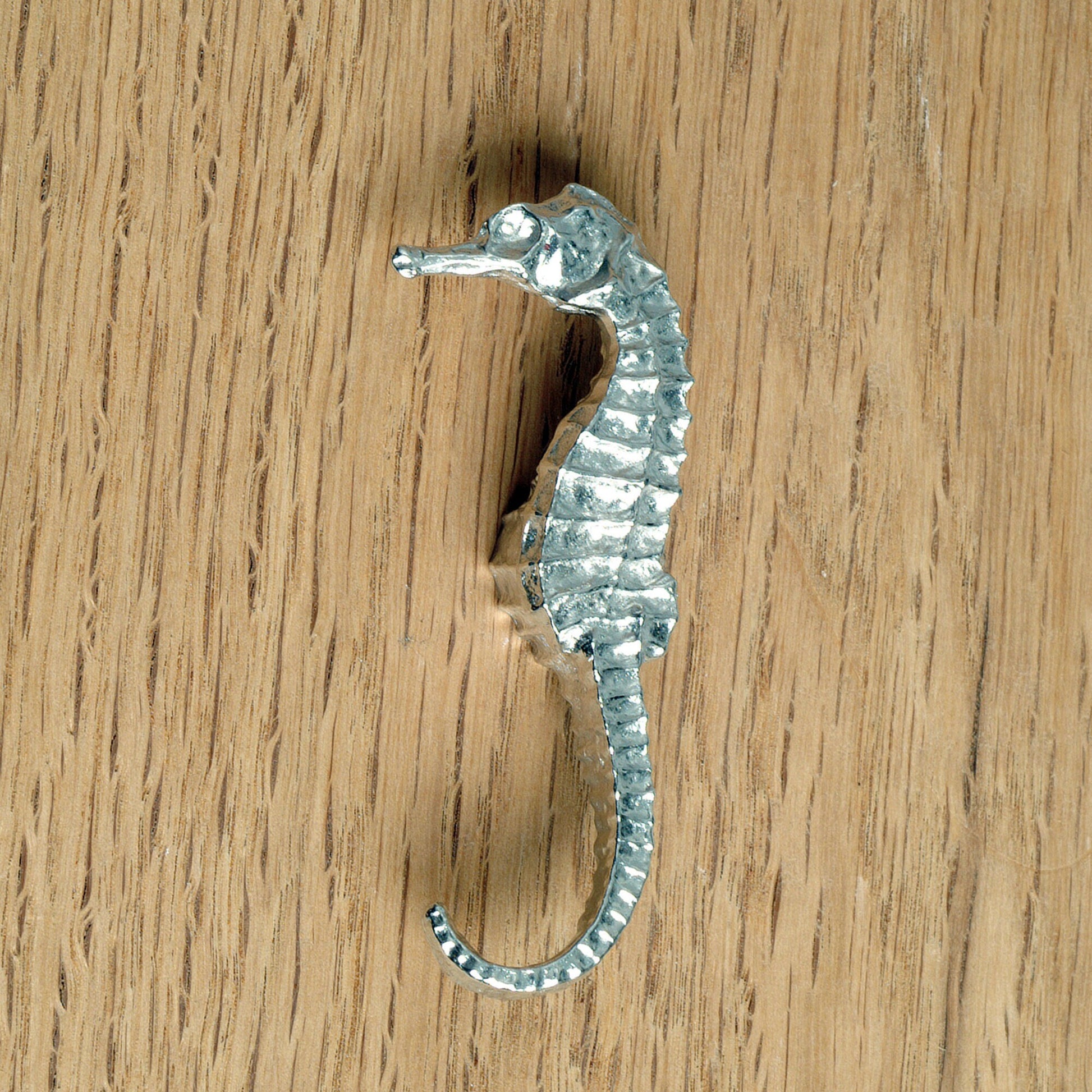 A solid pewter cabinet handle, cupboard knob, furniture handle or drawer pull in the shape of a detailed seahorse. Organic, unusual handles UK handmade with finesse