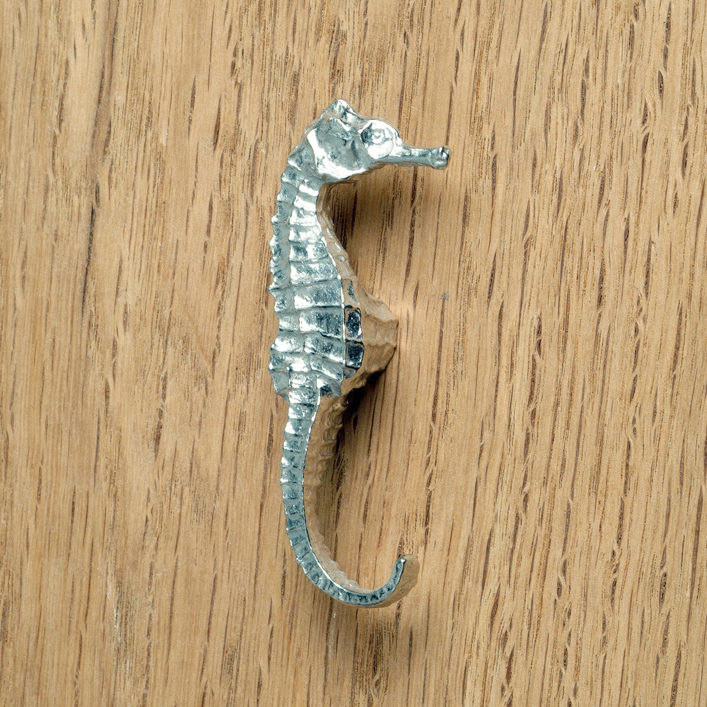 A solid pewter cabinet handle, cupboard knob, furniture handle or drawer pull in the shape of a detailed seahorse. Organic, unusual handles UK handmade with finesse