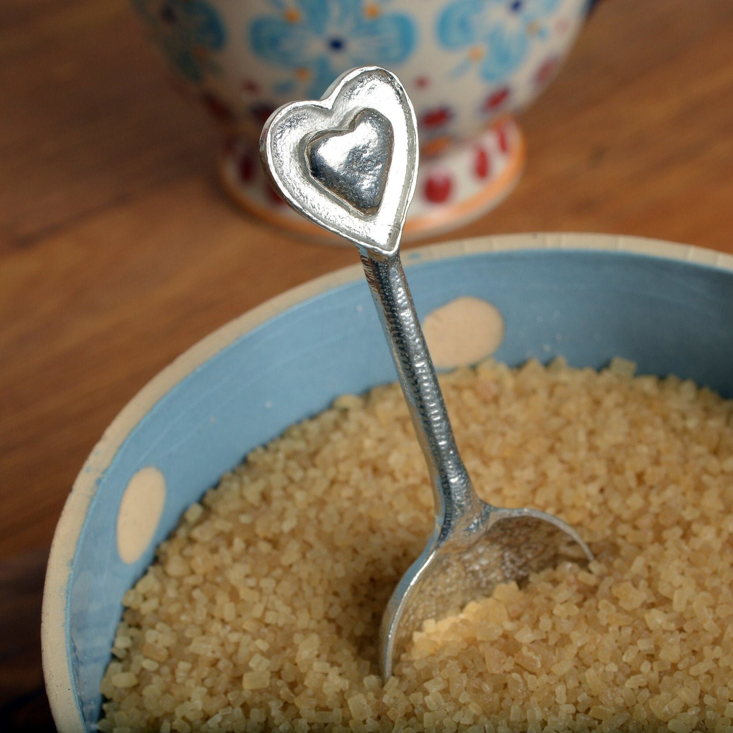 A small spoon pewter sugar spoon  with 2 love hearts on the end. Our love spoon makes an ideal little love token or 10th tin wedding anniversary gift or small wedding gift.