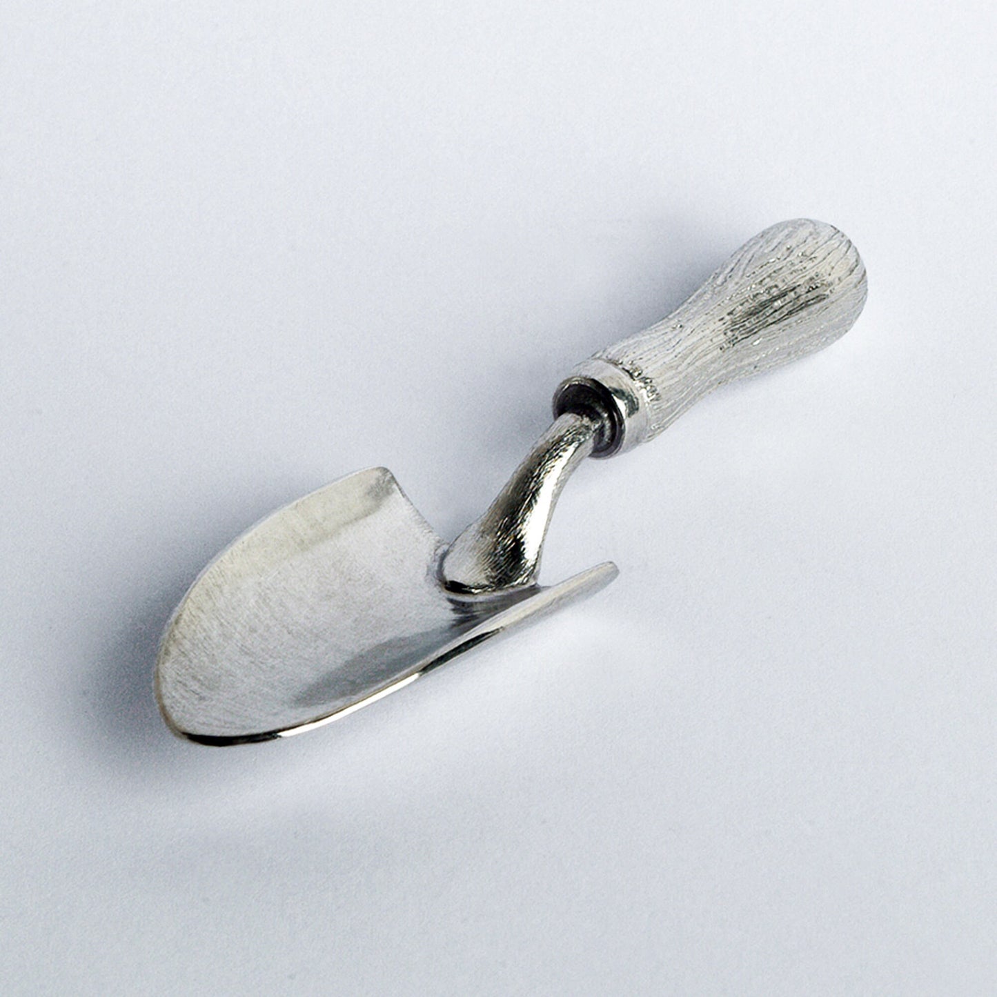 A small spoon pewter sugar spoon in the shape of a garden trowel . Unusual, useful and tactile gifts for gardeners and garden lovers handmade in the UK useful countryside gifts