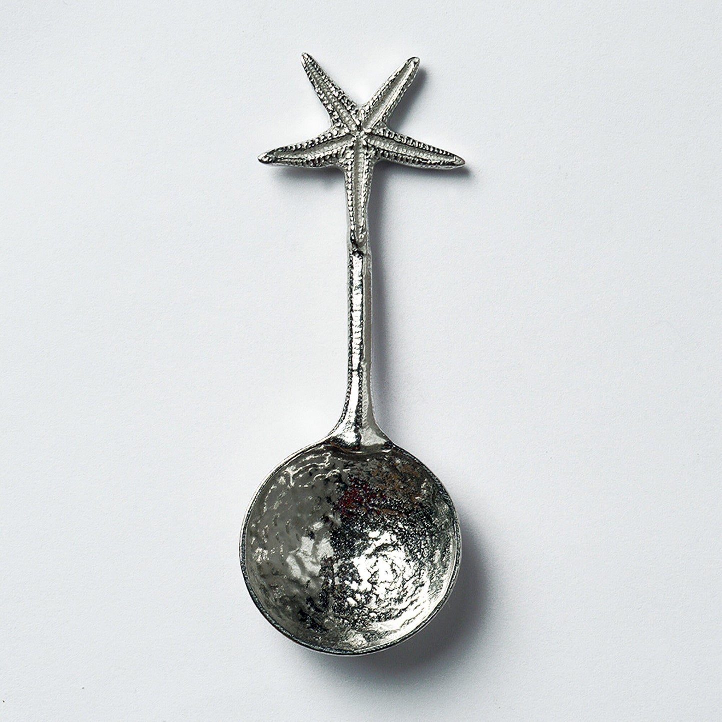 A small spoon pewter sugar spoon. A round bowled spoon on a straight handle leads to a perfectly sculpted starfish. Practical & useful nautical gifts for starfish lovers. UK handmade