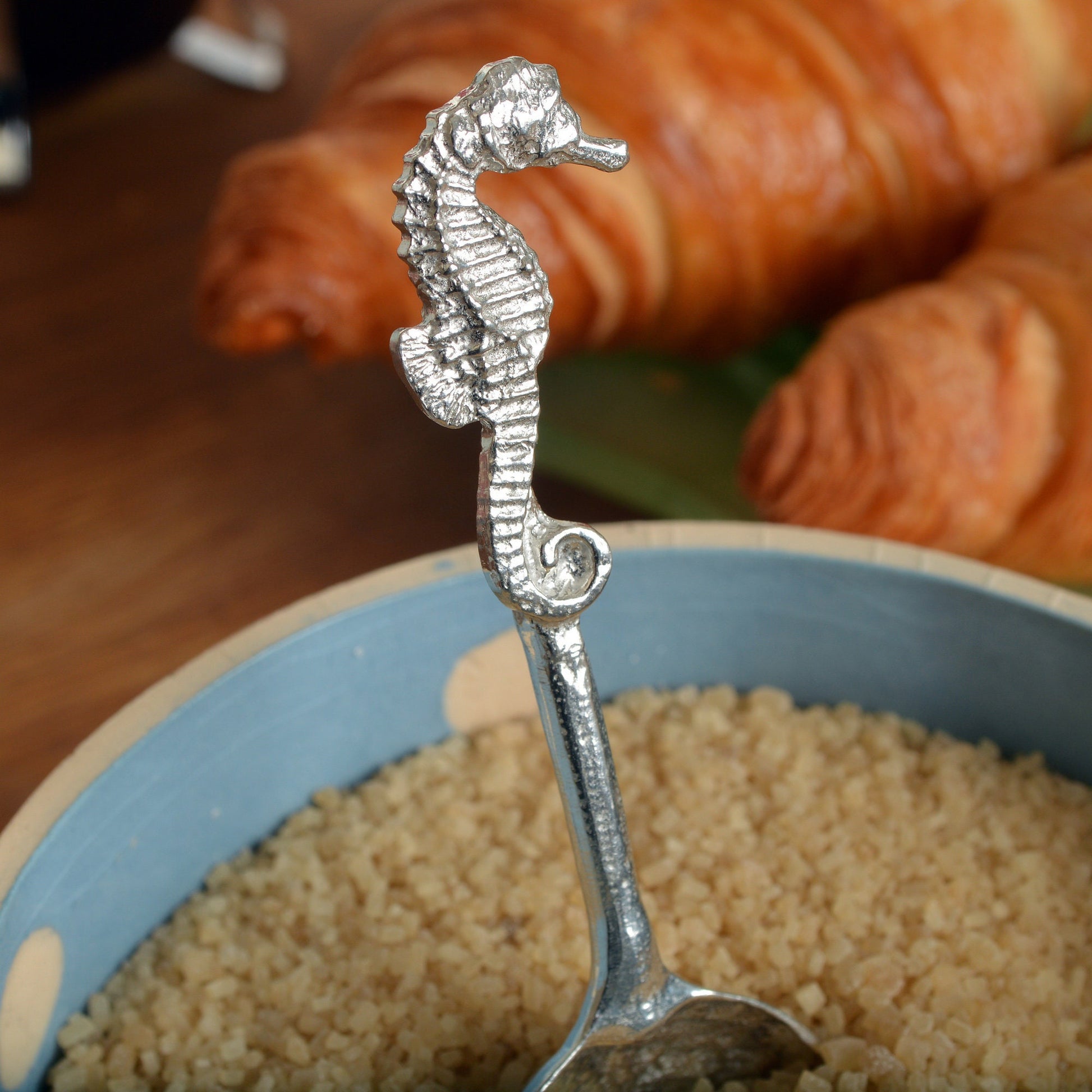 A small spoon pewter sugar spoon. A round bowled spoon on a straight handle leads to a perfectly sculpted seahorse. Practical & useful nautical gifts for seahorse lovers. UK handmade