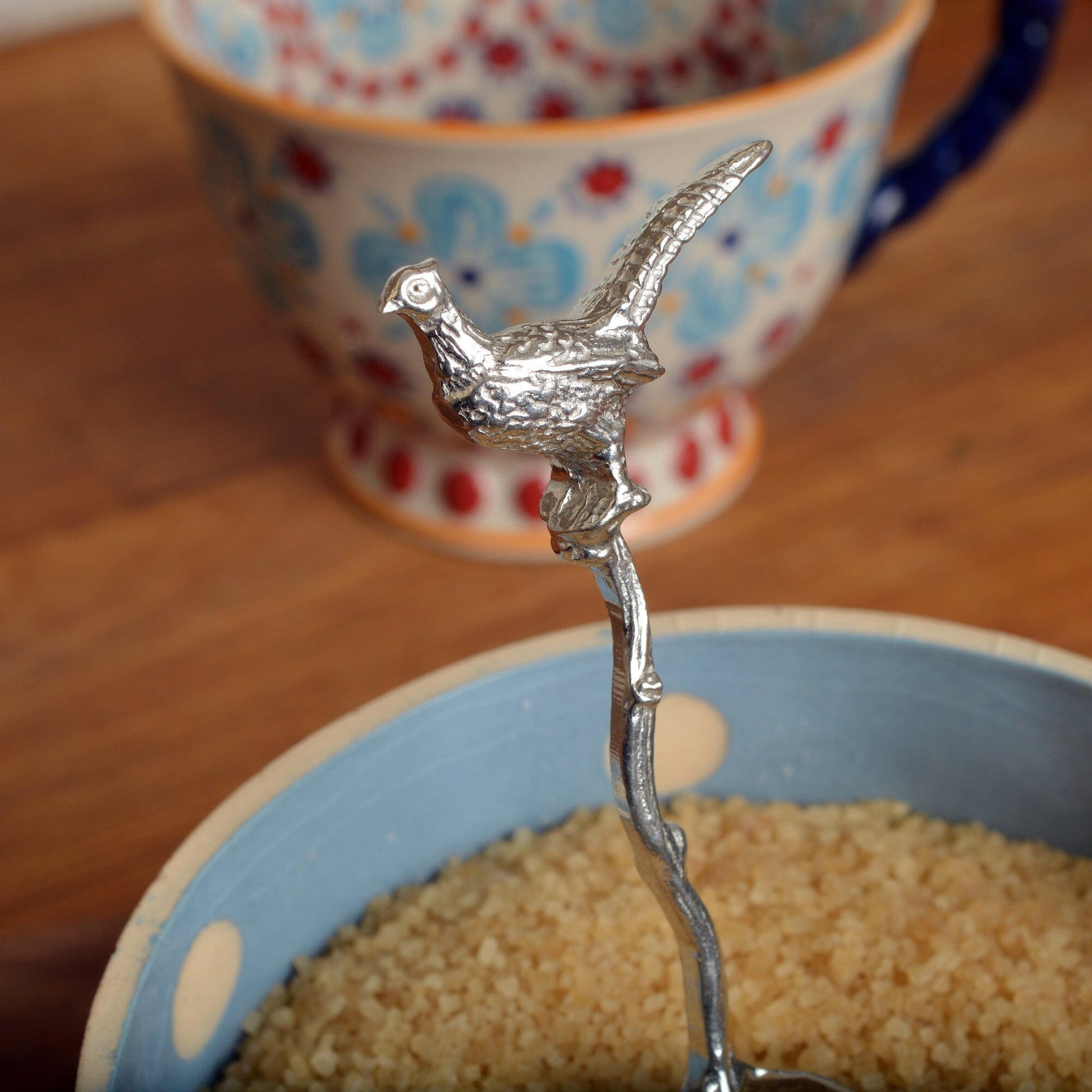 A small spoon pewter sugar spoon with a detailed pheasant on  a twig handle. Unusual, useful and tactile gifts for nature lovers, pheasant shooting gifts handmade in the UK useful countryside gifts