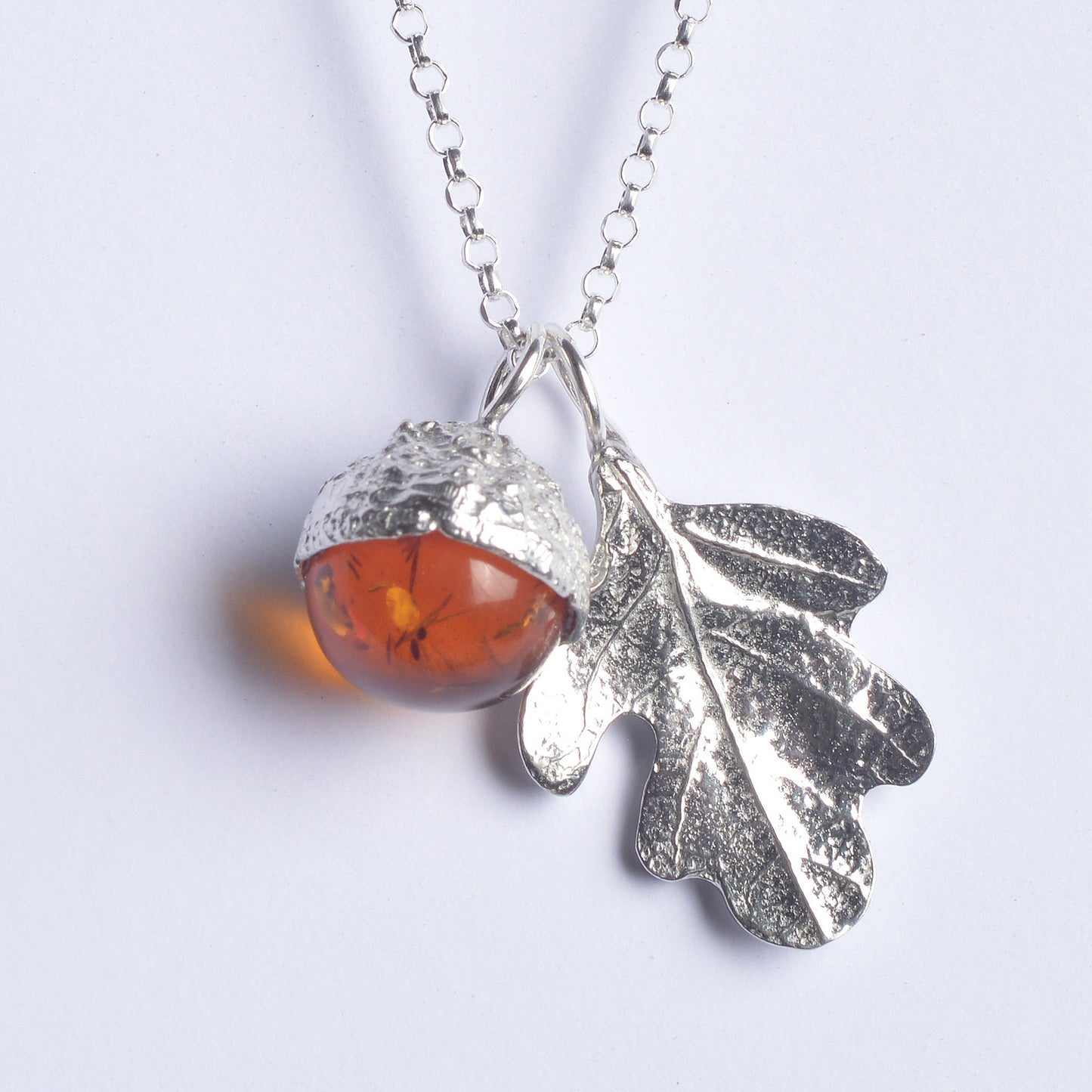 A delicate and detailed pewter oak leaf and amber acorn necklace on an 18" Sterling silver chain. A real amber stone in an acorn cup. Great jewellery gifts for her. The perfect 10th tin 10 year wedding anniversary gift (Our pewter is 95% tin). Made in Britain with love.