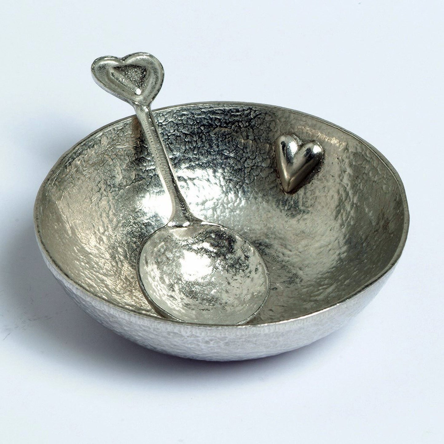 A 9cm diameter textured, circular pewter bowl, with a beautiful, yet subtle heart on the inside of the dish, comes with an accompanying heart love spoon. A perfect 10th (Tin) ten year wedding anniversary gift (Our pewter is 95% tin).