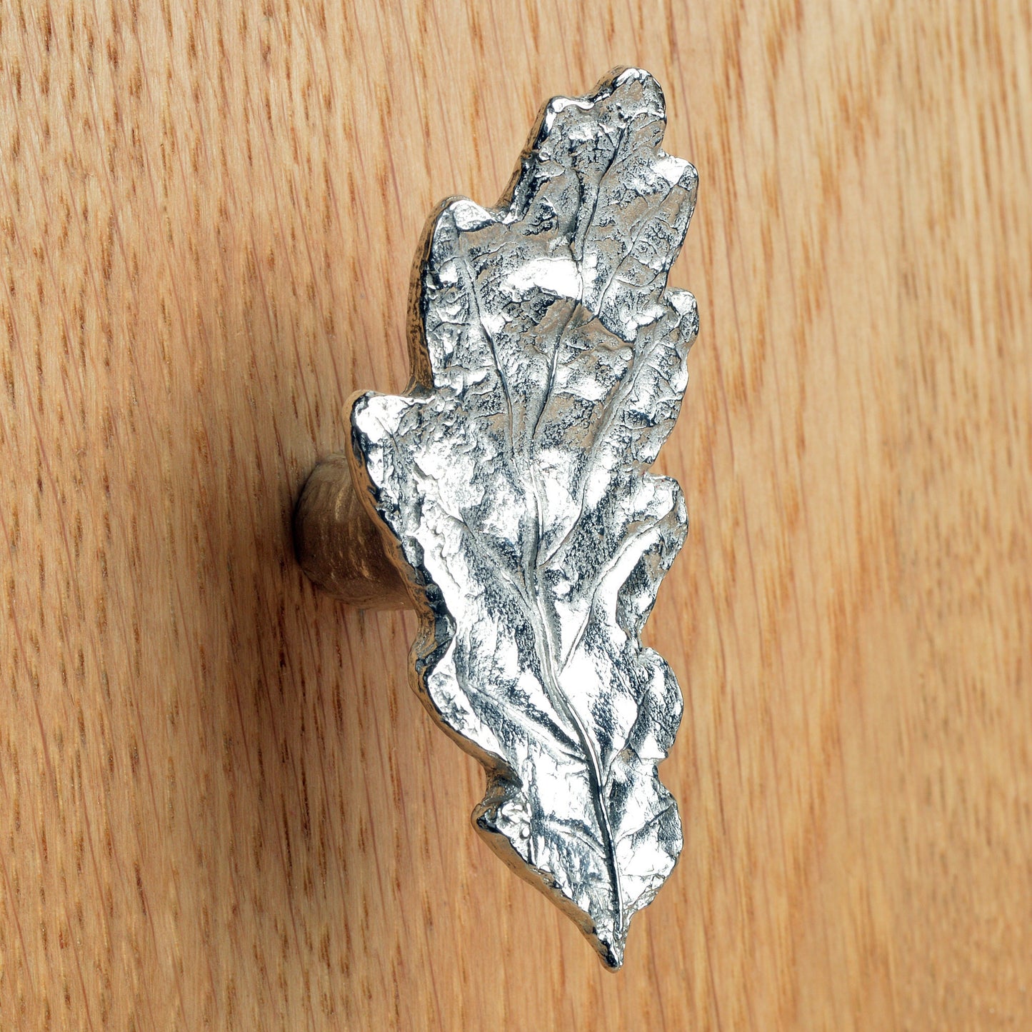 A solid pewter cabinet handle, cupboard knob, furniture handle or drawer pull in the shape of a detailed oak leaf. Organic, unusual handles UK handmade with finesse