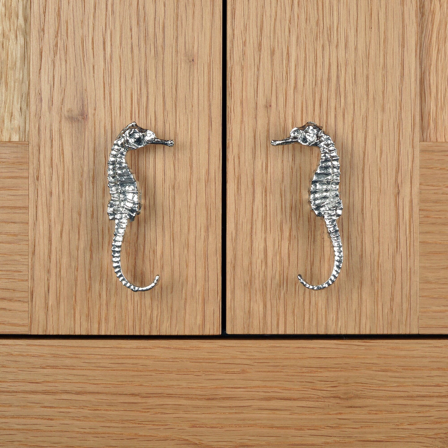 A solid pewter cabinet handle, cupboard knob, furniture handle or drawer pull in the shape of a detailed seahorse. Organic, unusual handles UK handmade with finesse