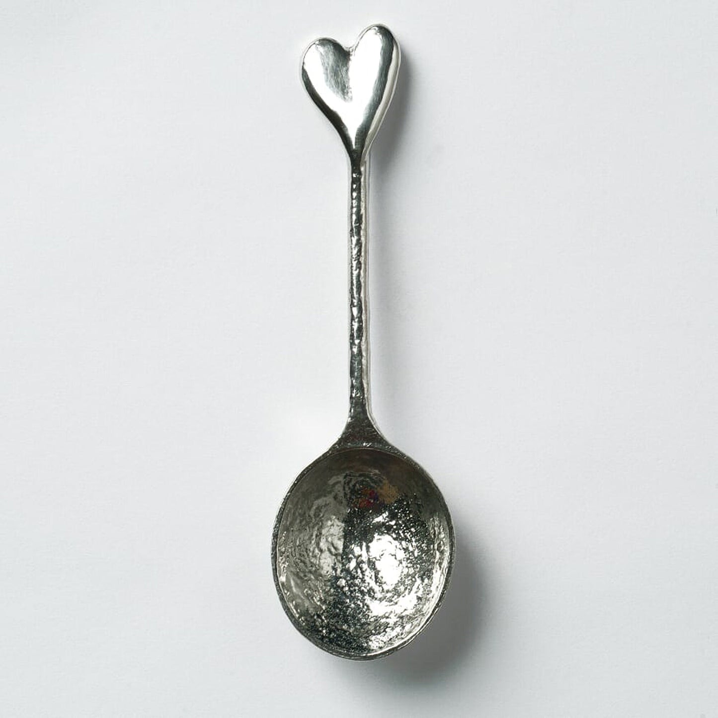 A small spoon pewter sugar teaspoon  with a love heart on the end. Our love spoon makes an ideal little love token or 10th tin wedding anniversary gift or small wedding gift.