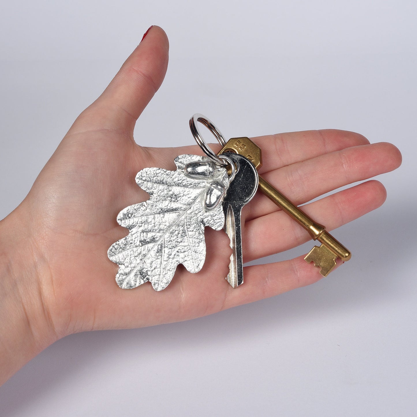 A detailed and beautifully textured oak leaf and acorn keyring. A large, strong and sturdy English pewter oak leaf keyring on a stainless steel ring. Oak and acorn gifts, housewarming gifts UK handmade