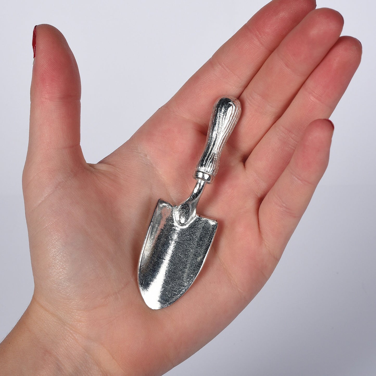 A small spoon pewter sugar spoon in the shape of a garden trowel . Unusual, useful and tactile gifts for gardeners and garden lovers handmade in the UK useful countryside gifts