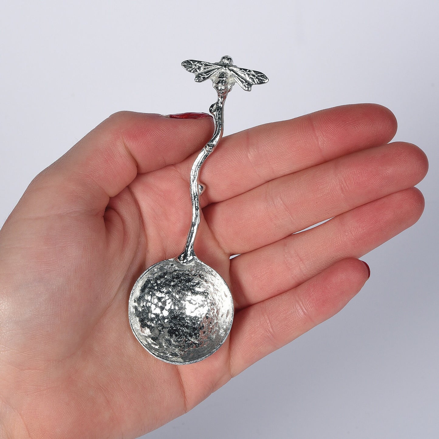 A small spoon pewter sugar spoon with a bee on the end of a twig handle. Unusual, useful and tactile gifts for bee lovers, bee gifts handmade in the UK