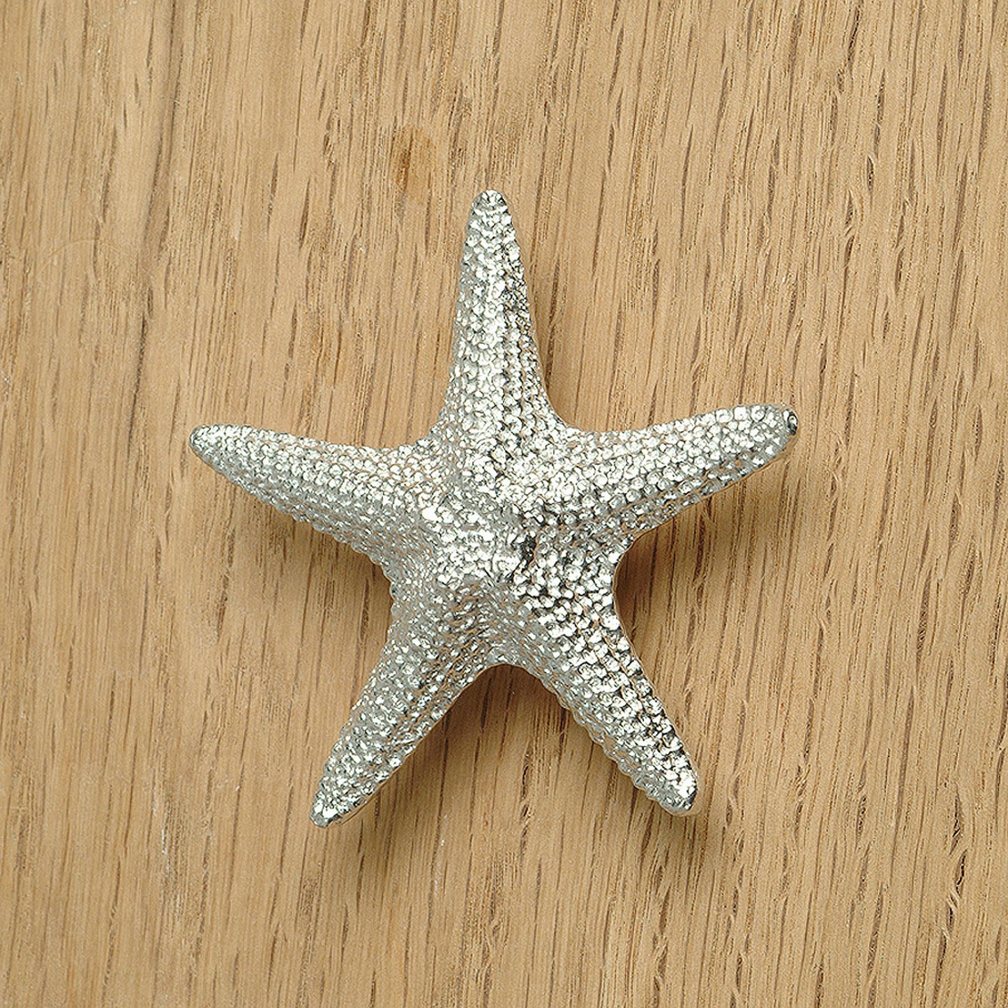 A solid pewter cabinet handle, cupboard knob, furniture handle or drawer pull in the shape of a detailed starfish. Organic, unusual handles UK handmade with finesse