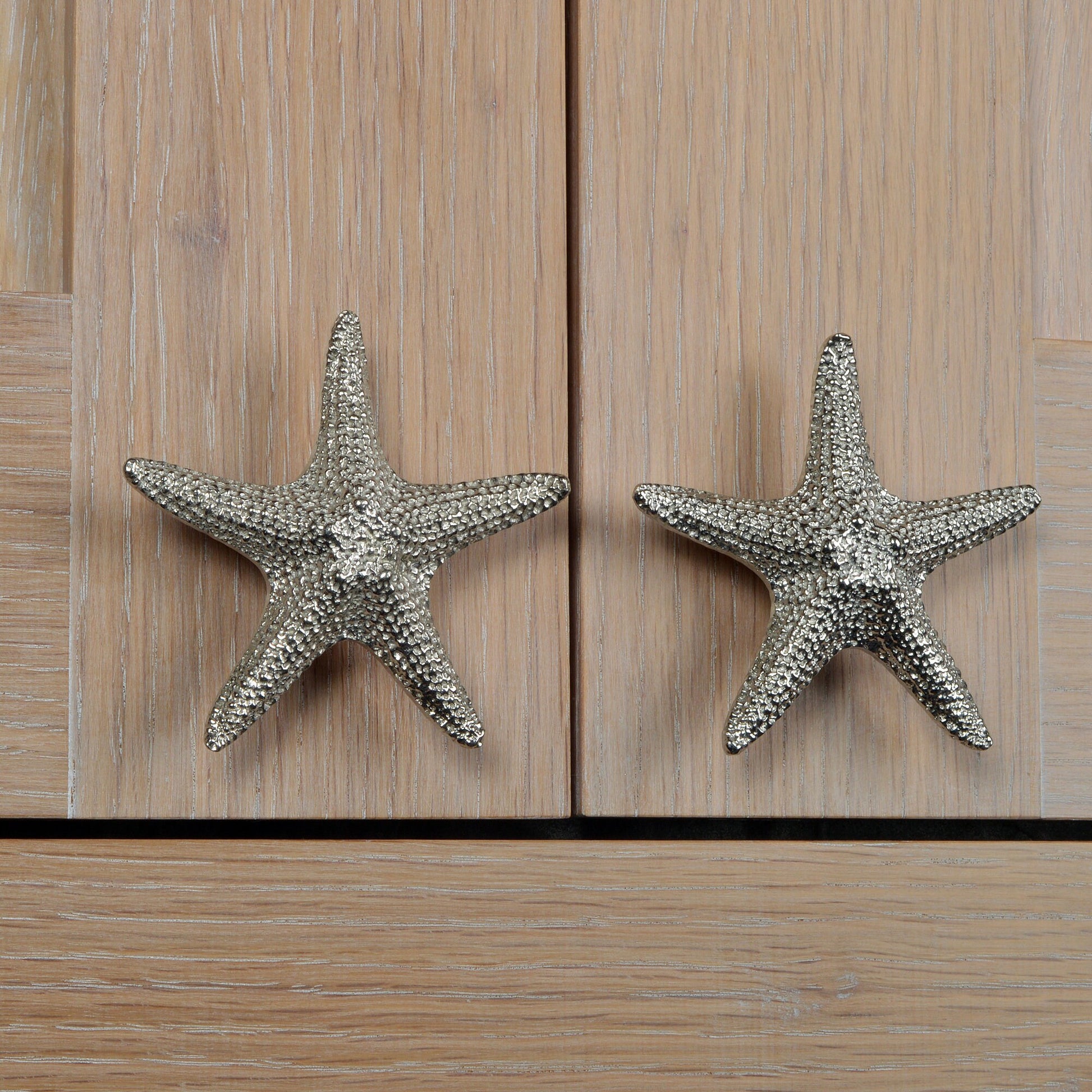 A solid pewter cabinet handle, cupboard knob, furniture handle or drawer pull in the shape of a detailed starfish. Organic, unusual handles UK handmade with finesse