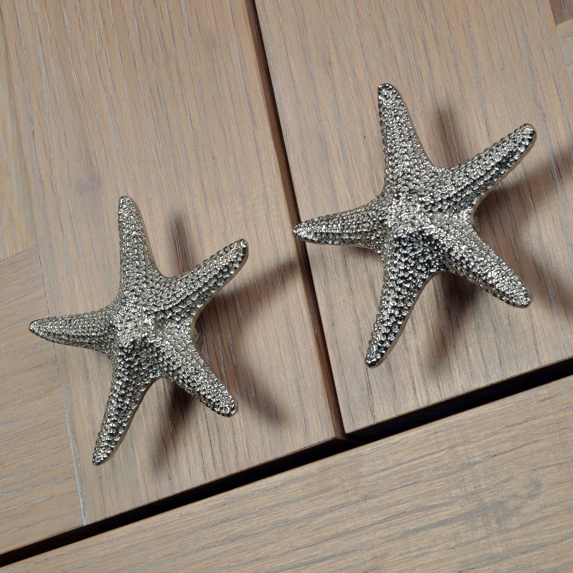 A solid pewter cabinet handle, cupboard knob, furniture handle or drawer pull in the shape of a detailed starfish. Organic, unusual handles UK handmade with finesse