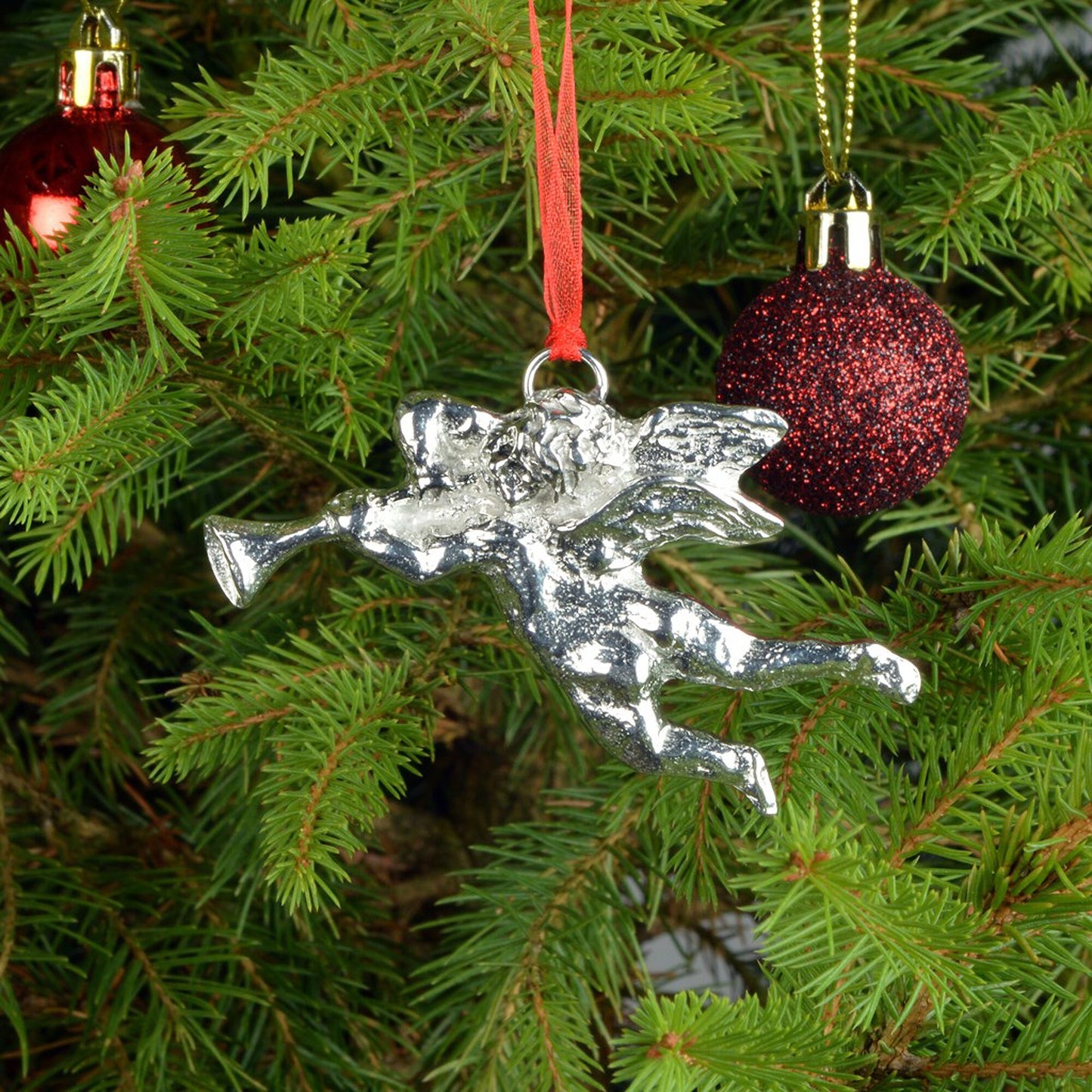 Our Cherub heralds in Christmas hanging from a red ribbon providing a gorgeous Christmas tree decoration gift. Pewter hanging Christmas tree decorations, unusual Christmas decorations made in Britain