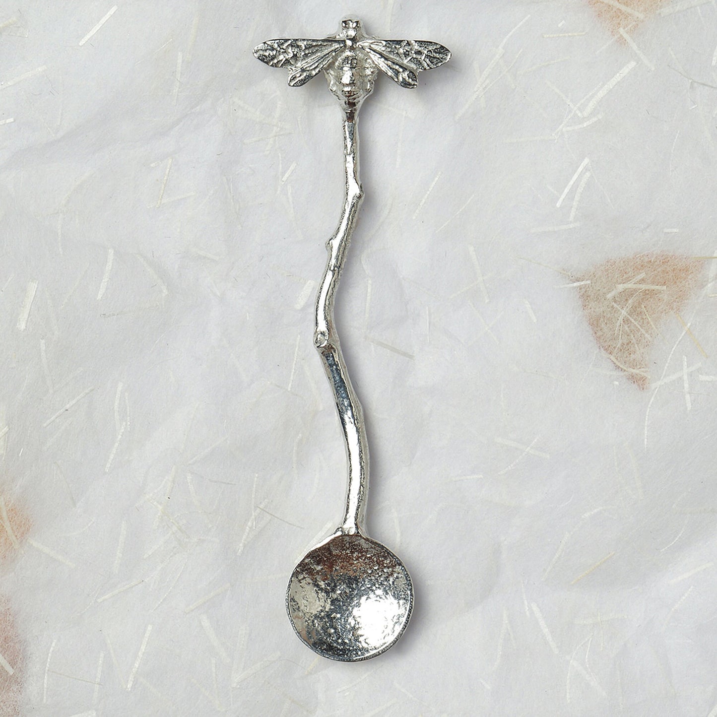 A small spoon pewter sugar spoon with a bee on the end of a twig handle. Unusual, useful and tactile gifts for bee lovers, bee gifts handmade in the UK