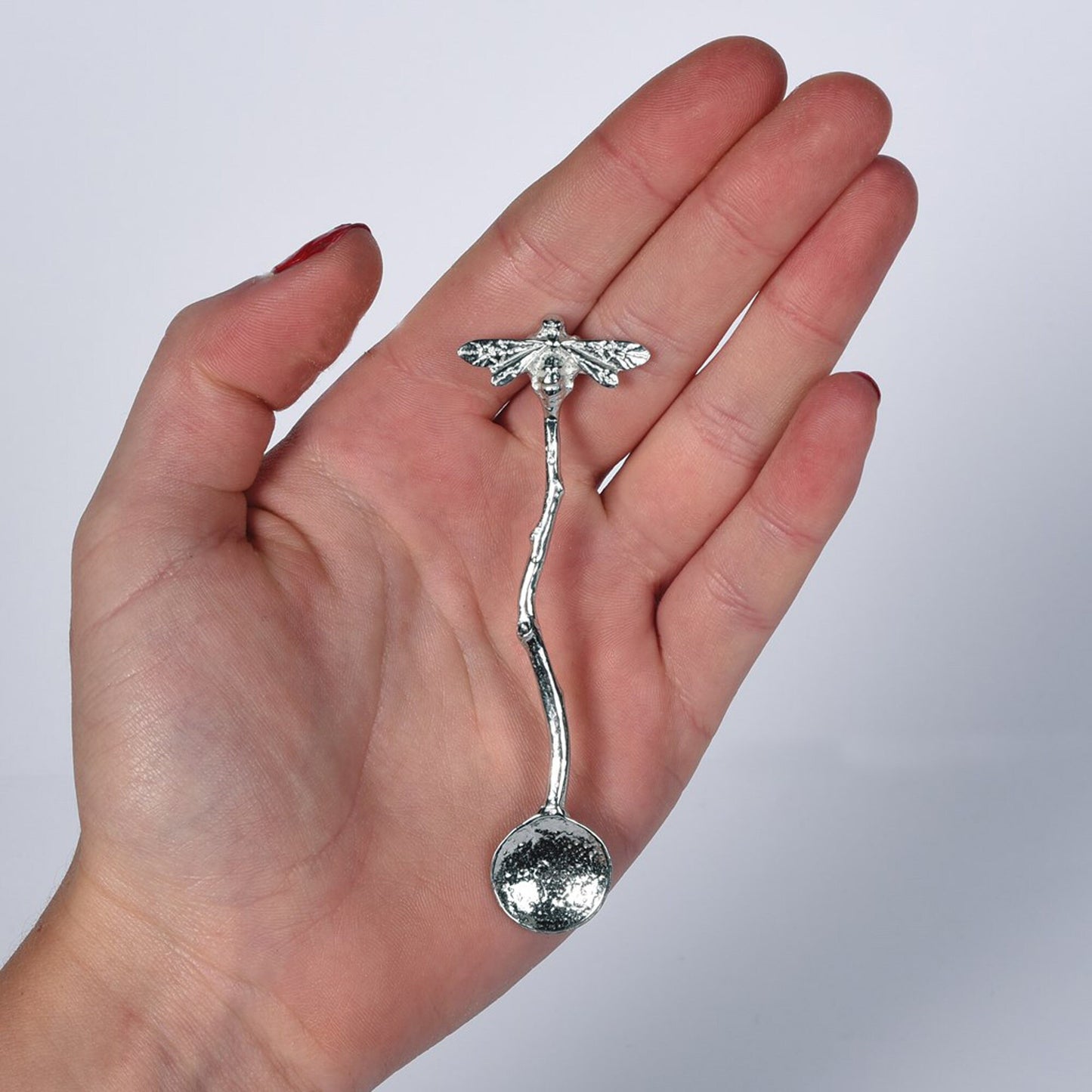 A small spoon pewter sugar spoon with a bee on the end of a twig handle. Unusual, useful and tactile gifts for bee lovers, bee gifts handmade in the UK