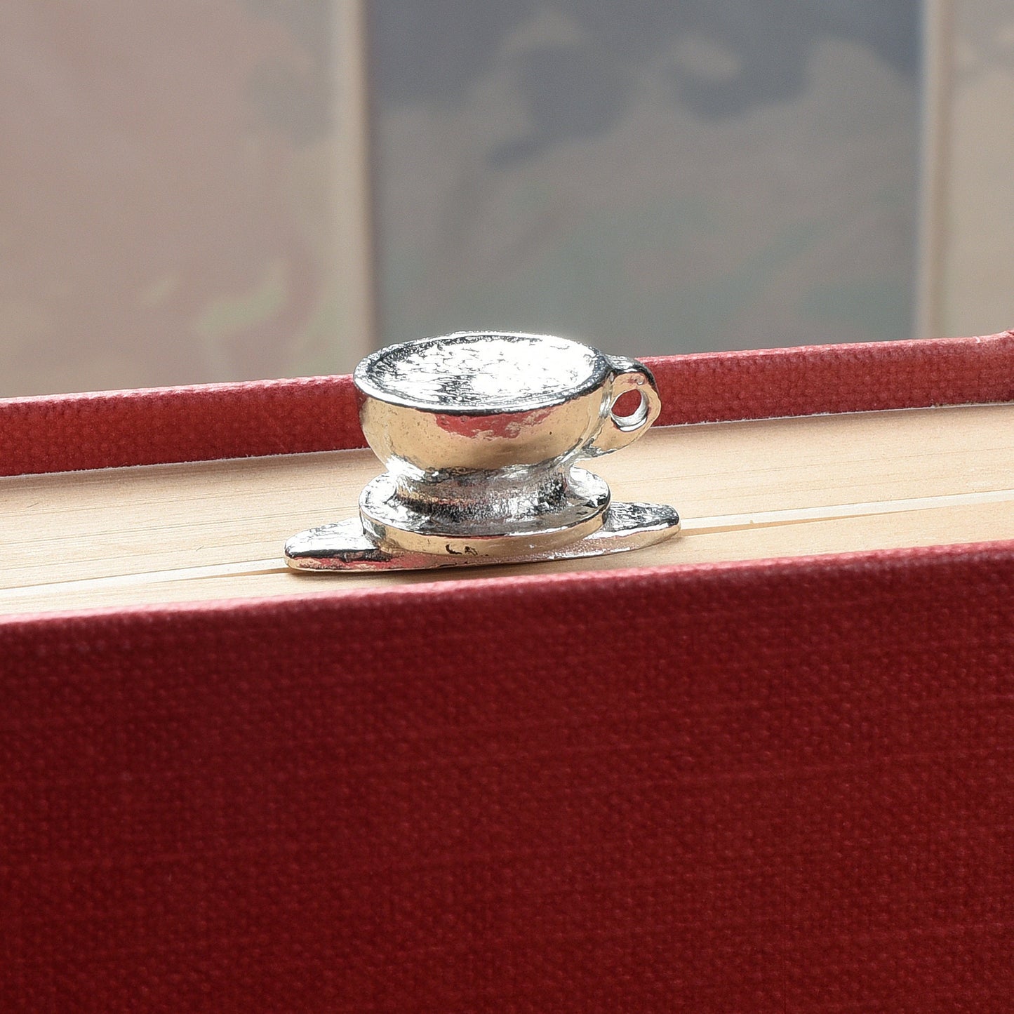 A personalised engraved pewter metal  bookmark with a coffee cup on the top. On the front the quotation 'Happiness is a cup of coffee and a good book'. We engrave the back with your message. Gifts for coffee lovers, book lovers gifts.