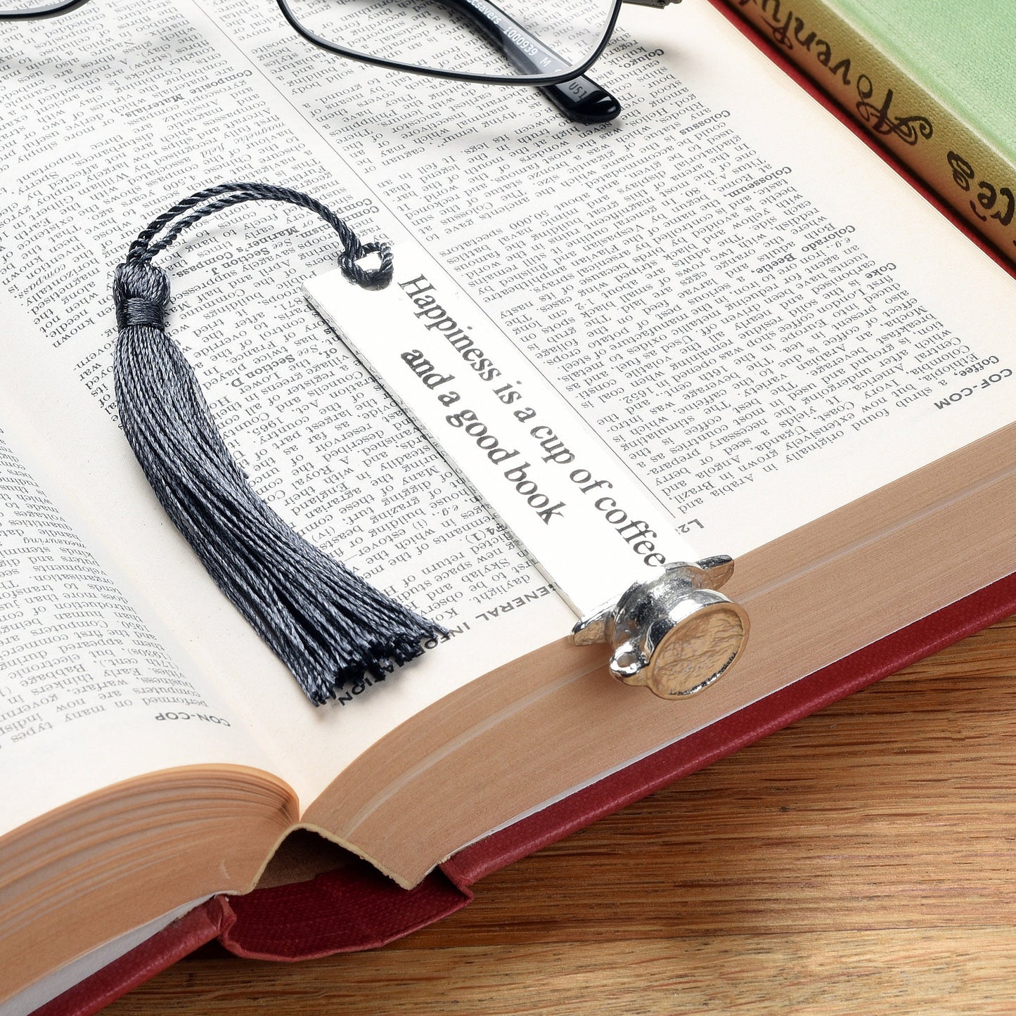 A personalised engraved pewter metal  bookmark with a coffee cup on the top. On the front the quotation 'Happiness is a cup of coffee and a good book'. We engrave the back with your message. Gifts for coffee lovers, book lovers gifts.